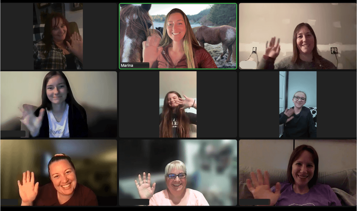 Video call with Marina and eight smiling students waving